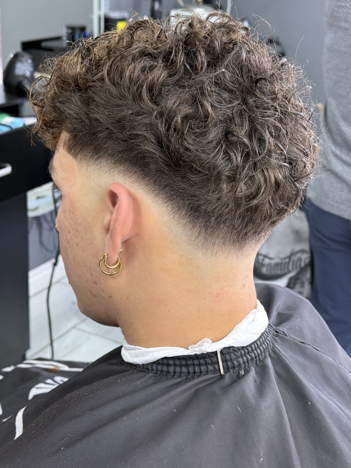 Curly taper fade, back view