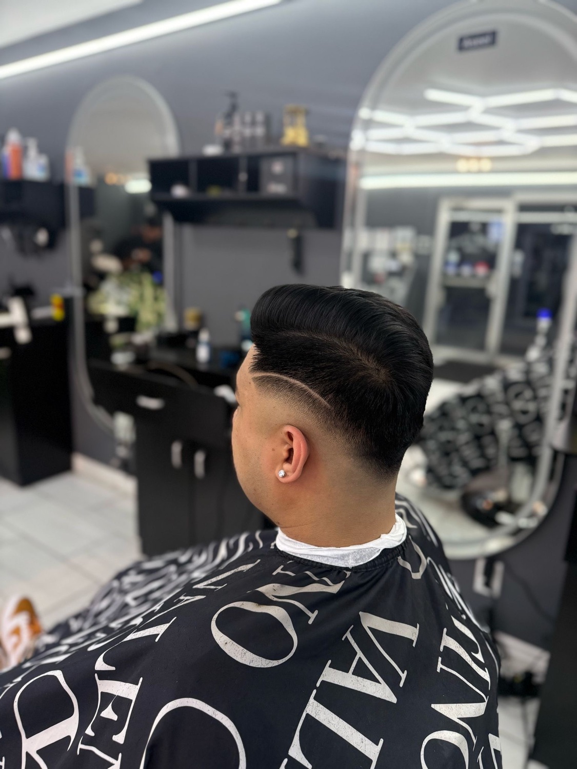 Pompadour with hard part and clean fade
